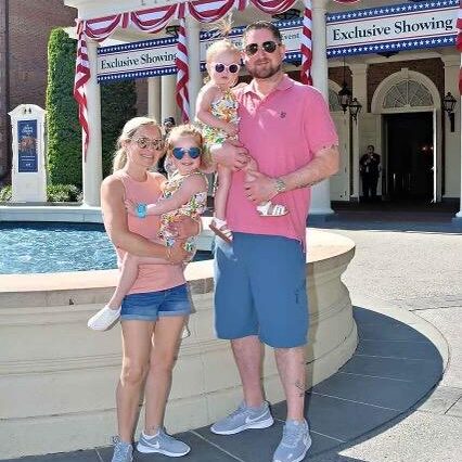 Husband and wife with their children at an amusement park